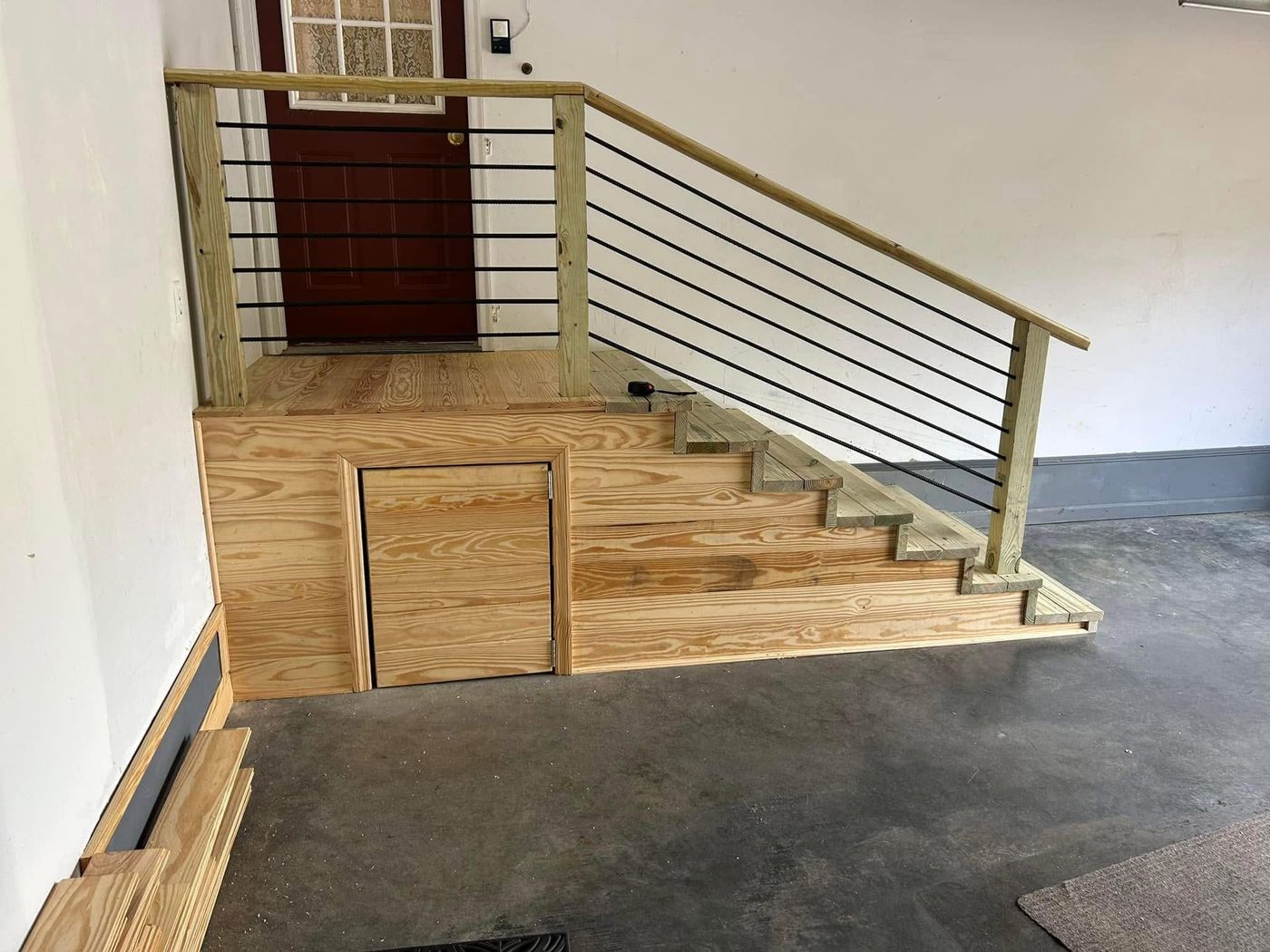 New pine staircase with steel rail built in a garage