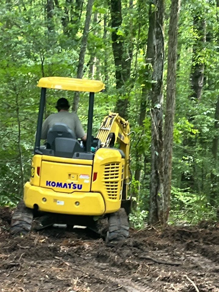 Komatsu excavator on a wooded hillside