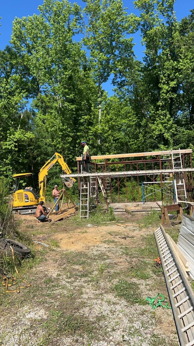 The crew setting a truss with the excavator