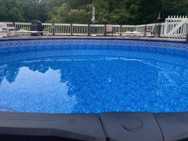 Above-ground pool full of clear blue water